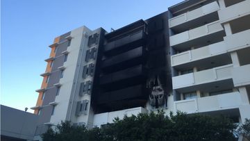 Fire flares up again at apartment building 