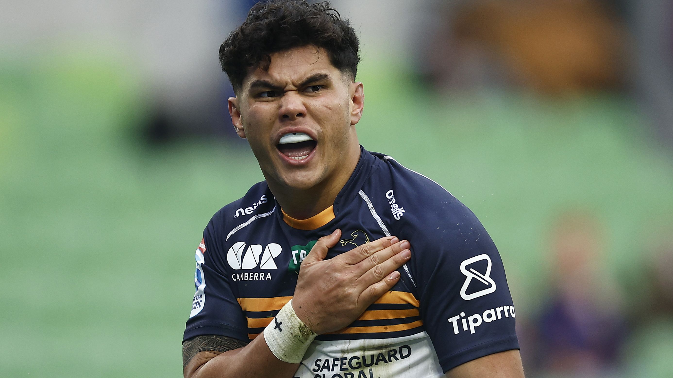 Noah Lolesio pounds his chest after scoring the first try for the Brumbies against the Rebels.