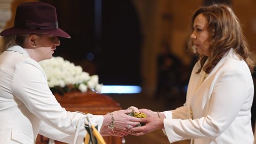 Les Murray's partner Maria (right) inside the church with another mourner. (AAP)