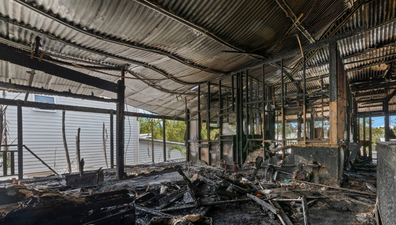 Buyers haggle over Brisbane's half-burnt house as it gets passed in at auction. Negotiations are underway to close the deal.