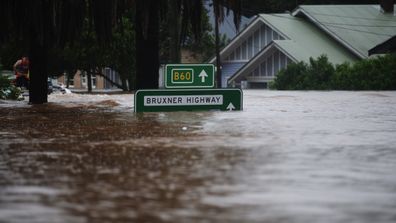 A road sign shows the scale of the historic floods.