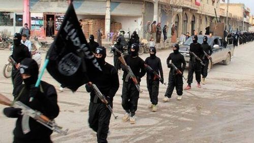 An undated photo showing ISIL fighters marching in Raqqa, Syria. (AP Photo)