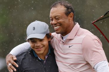 Tiger Woods of the United States embraces son Charlie Woods on the 18th green during the first round of the PNC Championship at The Ritz-Carlton Golf Club on December 16, 2023 in Orlando, Florida. (Photo by Mike Mulholland/Getty Images)