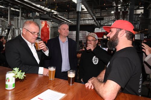 Australian Treasurer Scott Morrison (left) and Australian Finance Minister Mathias Cormann toast with Dan Watters of Capital Brewery and Andy Orrell from Hairyman Brewery during a visit to Capital Brewing Co in Canberra. Picture: AAP