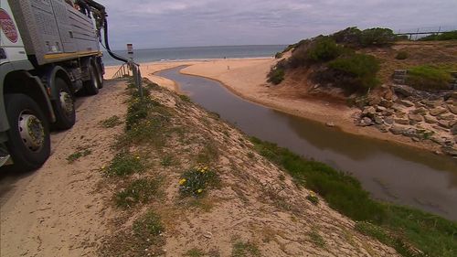 Christies Beach is usually full of swimmers, but today there were signs warning of the health risks of swimming in the sludge.