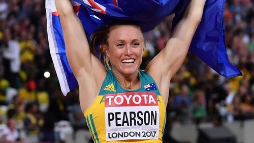 Australia's Sally Pearson celebrates with her national flag after winning the final of the women's 100m hurdles athletics event at the 2017 IAAF World Championships at the London Stadium in London on August 12, 2017. (AFP)