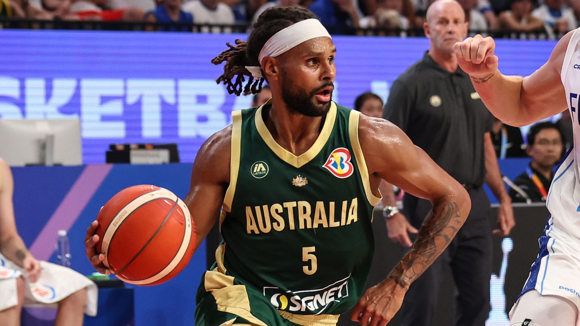 Patty Mills drives to the basket against Alex Murphy of Finland.