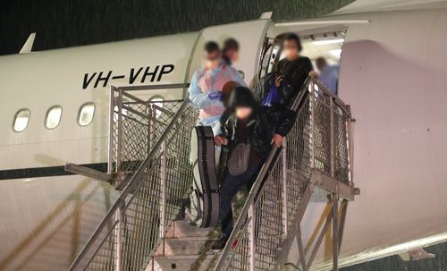 Passengers disembarking the plane at Christmas Island.