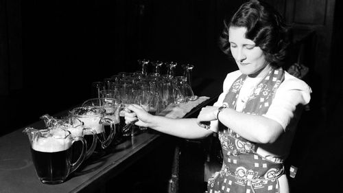 Pubs will allow 50 people from June 1 in NSW. Pictured: A barmaid awaiting the rush at 4.30, Friday, 15 November 1944 at the Grand Hotel in Hunter Street, Sydney.