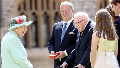 Queen Elizabeth II talks with the family of Captain Sir Thomas Moore Queen Elizabeth II talks with the family of Captain Sir Thomas Moore after awarding him with the insignia of Knight Bachelor at Windsor Castle on July 17, 2020 in Windsor, England.  (Photo by Chris Jackson/Getty Images)