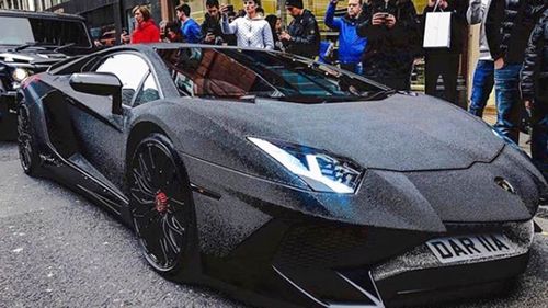 London bystanders stop to snap a picture of the crystal covered Lamborghini Aventador.