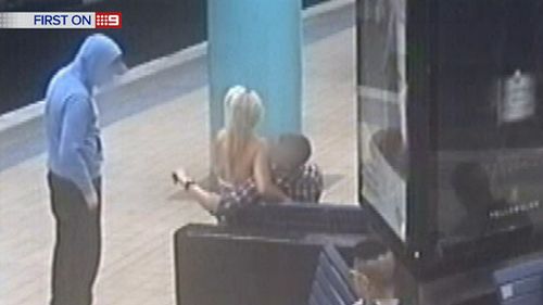 A loved-up teenage couple is distracted while a co-conspirator snatches handbag from around the pillar. (9NEWS)