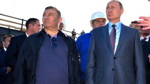 Russian President Vladimir Putin, is pictured alongside businessman and billionaire Arkady Rotenberg, who is the brother Boris Rotenberg.