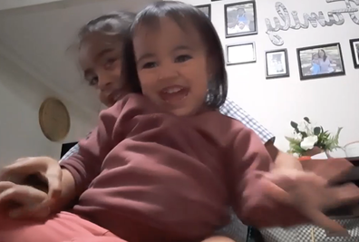 Fiapule playing with her older sister in a home video from before the ordeal began.