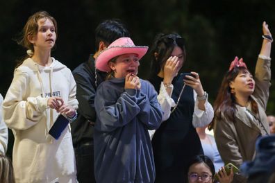 Taylor Swift fans, also known as "Swifties" with no tickets sing and dance during the concert outside the Melbourne Cricket Ground on February 16, 2024 in Melbourne, Australia.