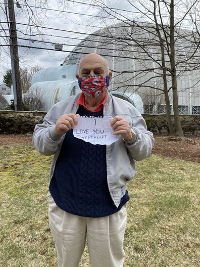 Nick carried a sign reading "I love you, sweetheart," to show his wife Marion.