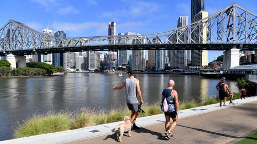 People are seen exercising along side the Brisbane River in Brisbane.