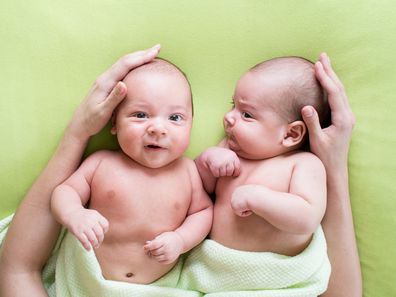 loving mother hands embrace twins babies