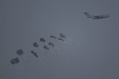 An aircraft airdrops humanitarian aid over northern Gaza Strip as seen from southern Israel, Thursday, March 28, 2024. 