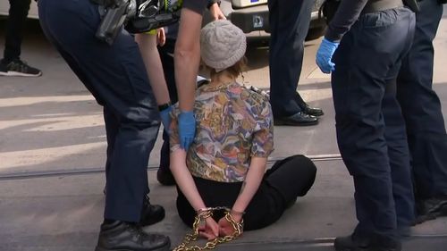 A protester being arrested in Melbourne's CBD 