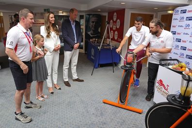 Tim Lawler CEO of SportsAid, Princess Charlotte of Cambridge, Catherine, Duchess of Cambridge and Prince William, Duke of Cambridge watch a demonstration of a bicycle powered smoothie maker during a visit to SportsAid House at the 2022 Commonwealth Games on August 02, 2022 in Birmingham, England. 