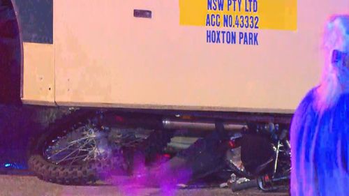 A bike trapped underneath a bus in Bossley Park. 