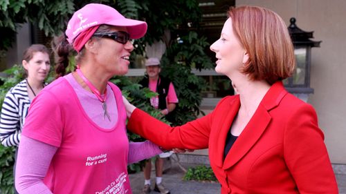 Deborah De Williams (left) meets then Prime Minister Julia Gillard at Parliament House in Canberra in 2011. Deborah was attempting a record breaking run around Australia to raise money for breast cancer research. (AAP)