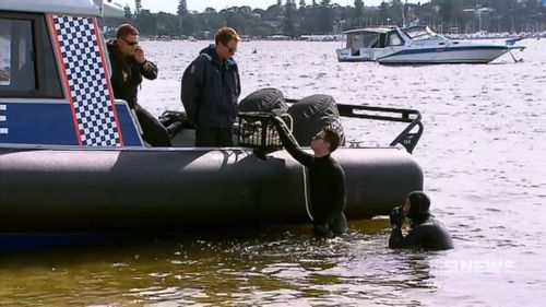 Divers searched for the mother's body in the Swan River.