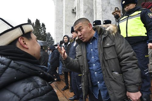 Protesters talk to each other as they gather in support of Kazakh opposition and against deploying Kyrgyzstan's troops to Kazakhstan during a rally in Bishkek, Kyrgyzstan, Friday, Jan. 7, 2022. 