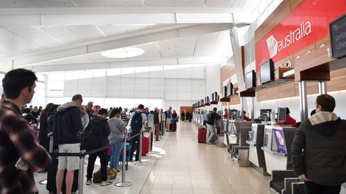 Virgin Australia customers are being checked in manually. (AAP)
