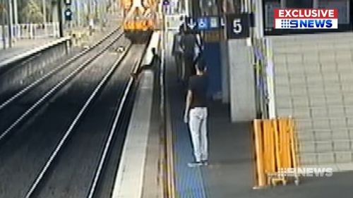 He throws something onto the tracks before getting out of the way. Picture: Supplied