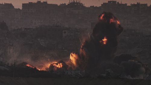 Smoke and fire rise to the sky following an Israeli airstrike in the northern Gaza Strip, as seen from southern Israel, Friday, July 18, 2025. (AP Photo/Leo Correa)