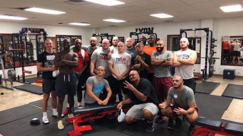 The players at Lyon College in Batesville, Arkansas, show off their shaved heads in the weight room.