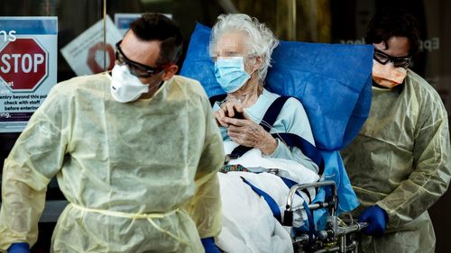 A resident of Epping Gardens Aged Care Facility is taken away in a ambulance during Victoria's coronavirus pandemic.