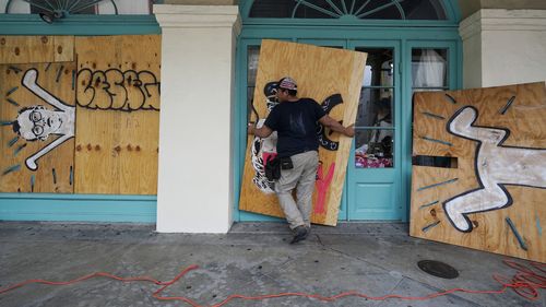 On Saturday, August 28, 2021, in the French Quarter of New Orleans, in response to Hurricane Ida, workers taped protective plywood to the doors and windows of a company (AP Photo/Eric Gay)