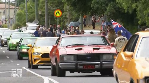 A convoy of more than 50 classic cars followed behind and stretched from suburb to suburb.