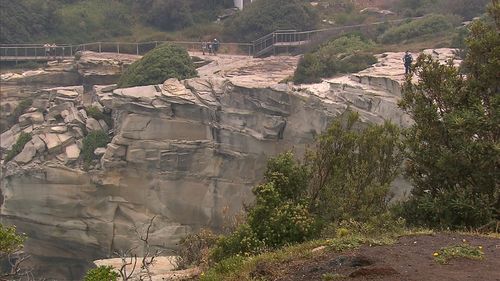 A woman, believed to be a British tourist, has died after falling down a cliff in Sydney's Eastern Suburbs.