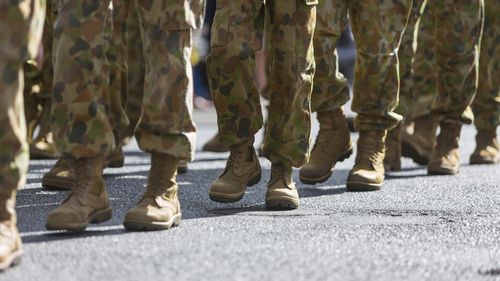 Feet of soldiers marching at an ANZAC Day parade on the streets of a regional country town
