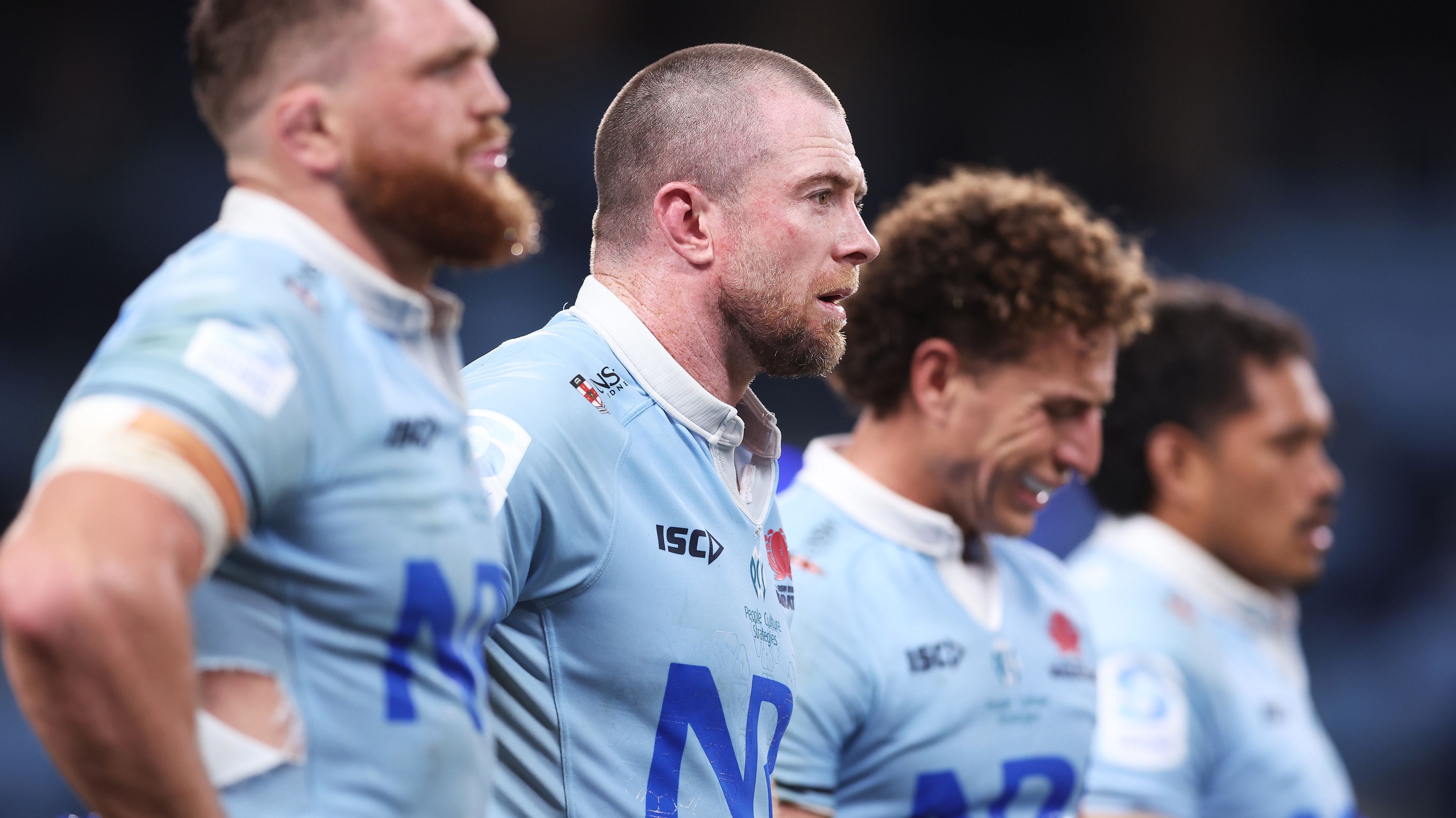 Jed Holloway and Waratahs teammates looks dejected after the final Rebels try during the round six Super Rugby Pacific match.