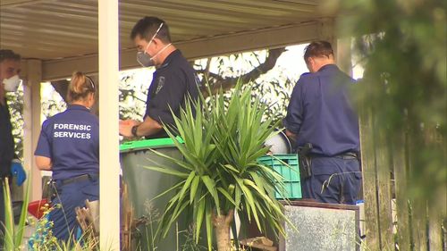 Forensic officers document the crime scene at which a 35-year-old man was fatally stabbed.