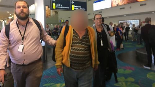 The accused man (centre) was extradited from Melbourne to Darwin today. Picture: 9NEWS