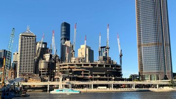 Cranes rise up from a construction site in Brisbane