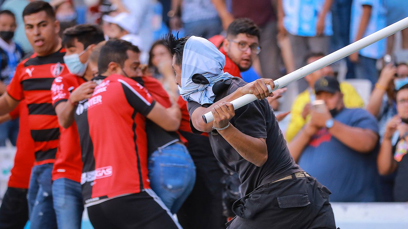Mexican football league suspended after wild crowd brawl leaves dozens hospitalised