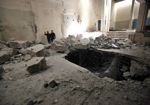 Iraqi forces inspect the damaged interior of the destroyed museum of Mosul on March 13, 2017 after it was recaptured by Iraqi forces from Islamic State (IS) group fighters. Iraqi forces seized the museum from IS on March 7 as they pushed into west Mosul as part of a vast offensive to oust the jihadists from the northern city.