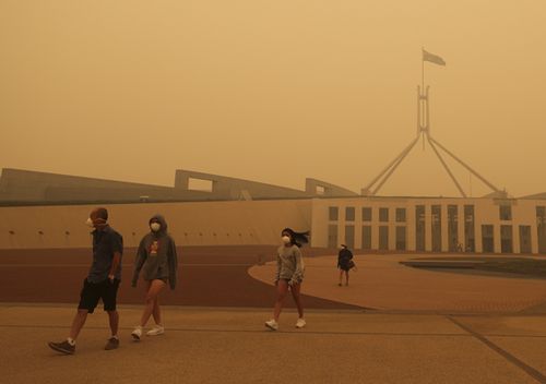 Visitors to Parliament House forced to wear face masks after smoke from bushfires blankets Canberra in a haze with hazardous air quality, on Sunday.