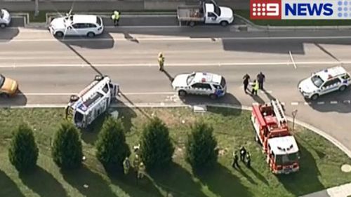 Ambulance rolls after crash north of Melbourne