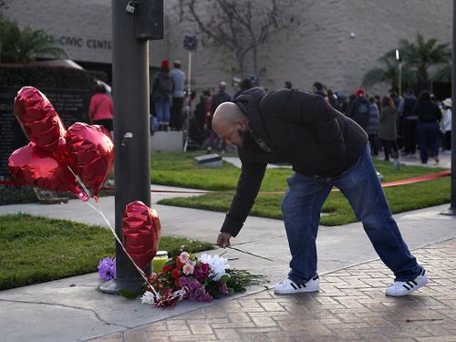 Pastor Abner Ramos pays his respects at a gathering to honor the victims killed in Saturday's ballroom dance studio shooting in Monterey Park, California.
