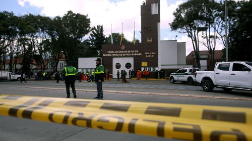 Colombian security forces at the Bogota police barracks that was the target of a deadly car bombing.