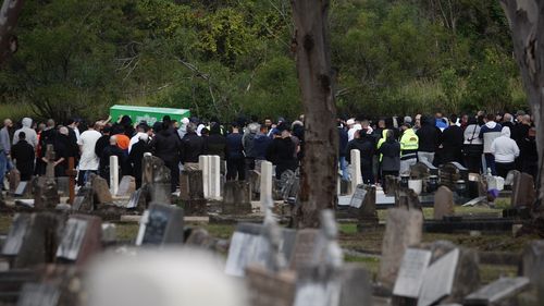 Bilal Hamze funeral. The coffin is carried through gathered mourners to its final resting place in Rookwood Cemetery.