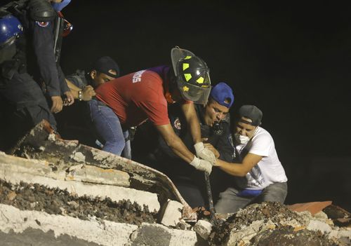 Crews working through the evening in Colonia Obrera. (AP)